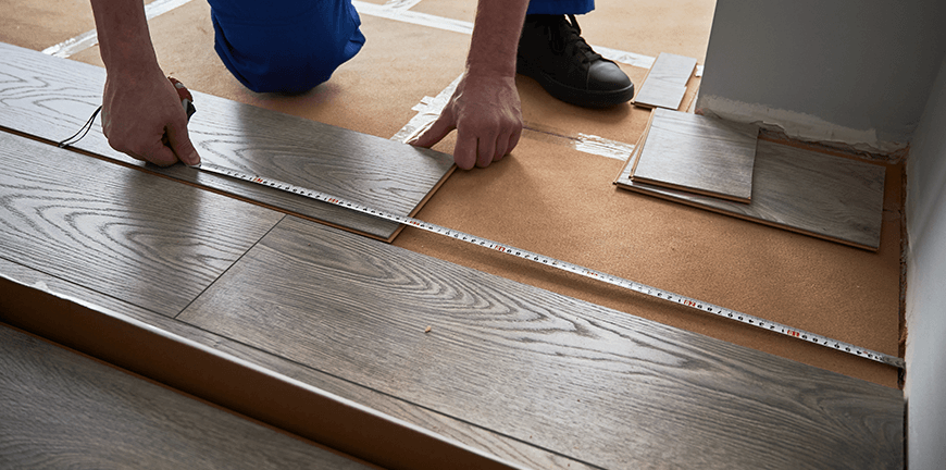 male-hands-measuring-distance-from-wall-to-laminat-2025-01-16-23-04-32-utc
